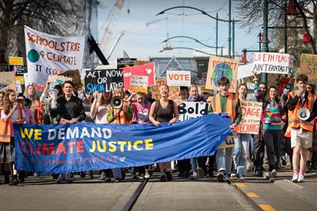 A group of people holding signs and holding a banner

AI-generated content may be incorrect.