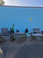 People walking next to a blue wall

AI-generated content may be incorrect.