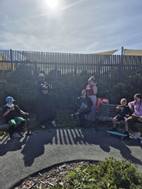 A group of people sitting on a bench

AI-generated content may be incorrect.