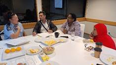A group of people sitting around a table

AI-generated content may be incorrect.