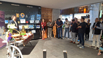 A group of people standing in a room

AI-generated content may be incorrect.