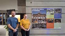 A person and person standing in front of a poster

AI-generated content may be incorrect.