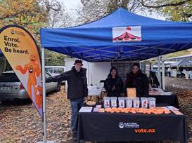 Three people standing under a gazebo at a Riccarton Rotary Market.
