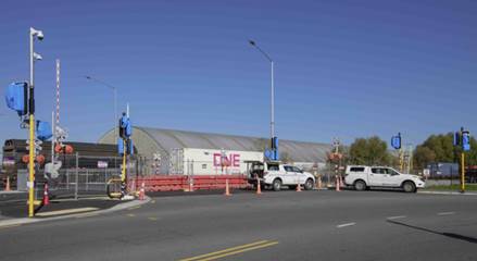 A wide shot of an intersection with a railway crossing.