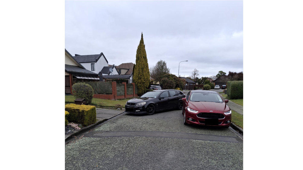 A couple of cars parked in a driveway

AI-generated content may be incorrect.