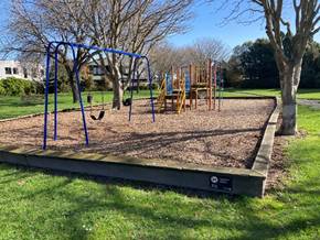 A playground with a swing set

AI-generated content may be incorrect.