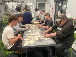 A group of people making food

AI-generated content may be incorrect.