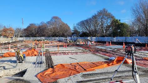 A construction site with orange tarps and poles

AI-generated content may be incorrect.