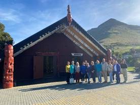 A group of people standing in front of a building

AI-generated content may be incorrect.