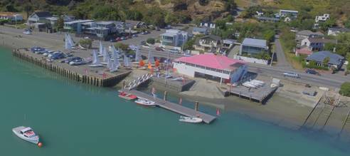 A dock with boats and buildings in the background

AI-generated content may be incorrect.