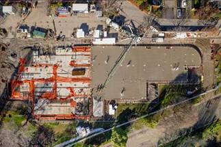 A building under construction with cranes

AI-generated content may be incorrect.