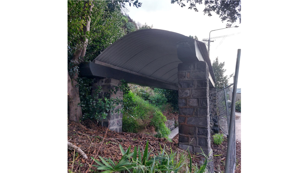 A stone structure with a metal roof

AI-generated content may be incorrect.