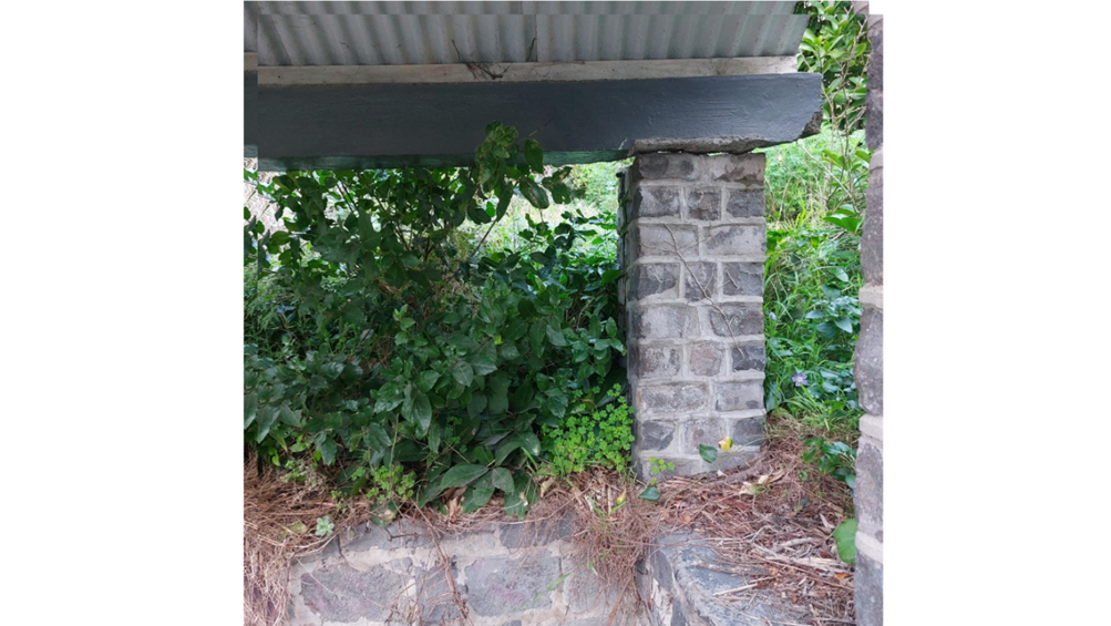 A stone pillar with a roof and plants

AI-generated content may be incorrect.