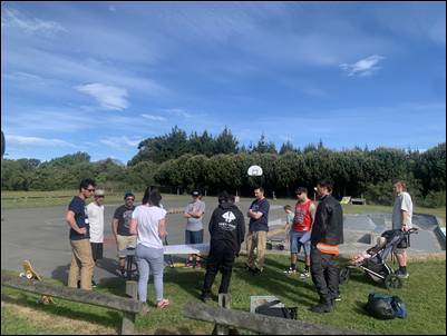 A group of people standing around a table

AI-generated content may be incorrect.