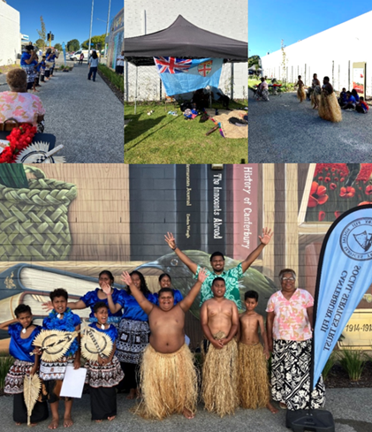 Photograph collage showing a cultural event with traditional Fijian dance and attire, including grass skirts and patterned clothing, set outdoors near a mural and a tent displaying the Fijian flag. Participants, including children and adults, pose and perform, highlighting cultural heritage and community celebration.
